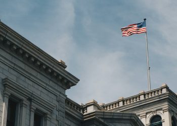 US Economy: A Balancing Act Between Resilience and Risk cover