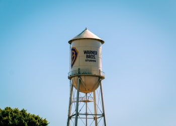 The warner bros. water tower against a blue sky.
