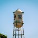 The warner bros. water tower against a blue sky.