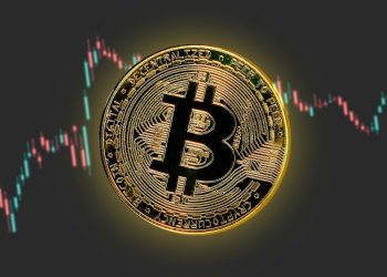a bitcoin is shown in front of a stock chart