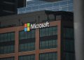 A tall building with a microsoft logo on top of it