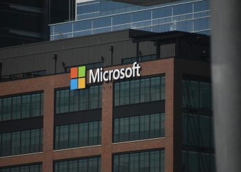 A tall building with a microsoft logo on top of it