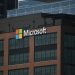A tall building with a microsoft logo on top of it